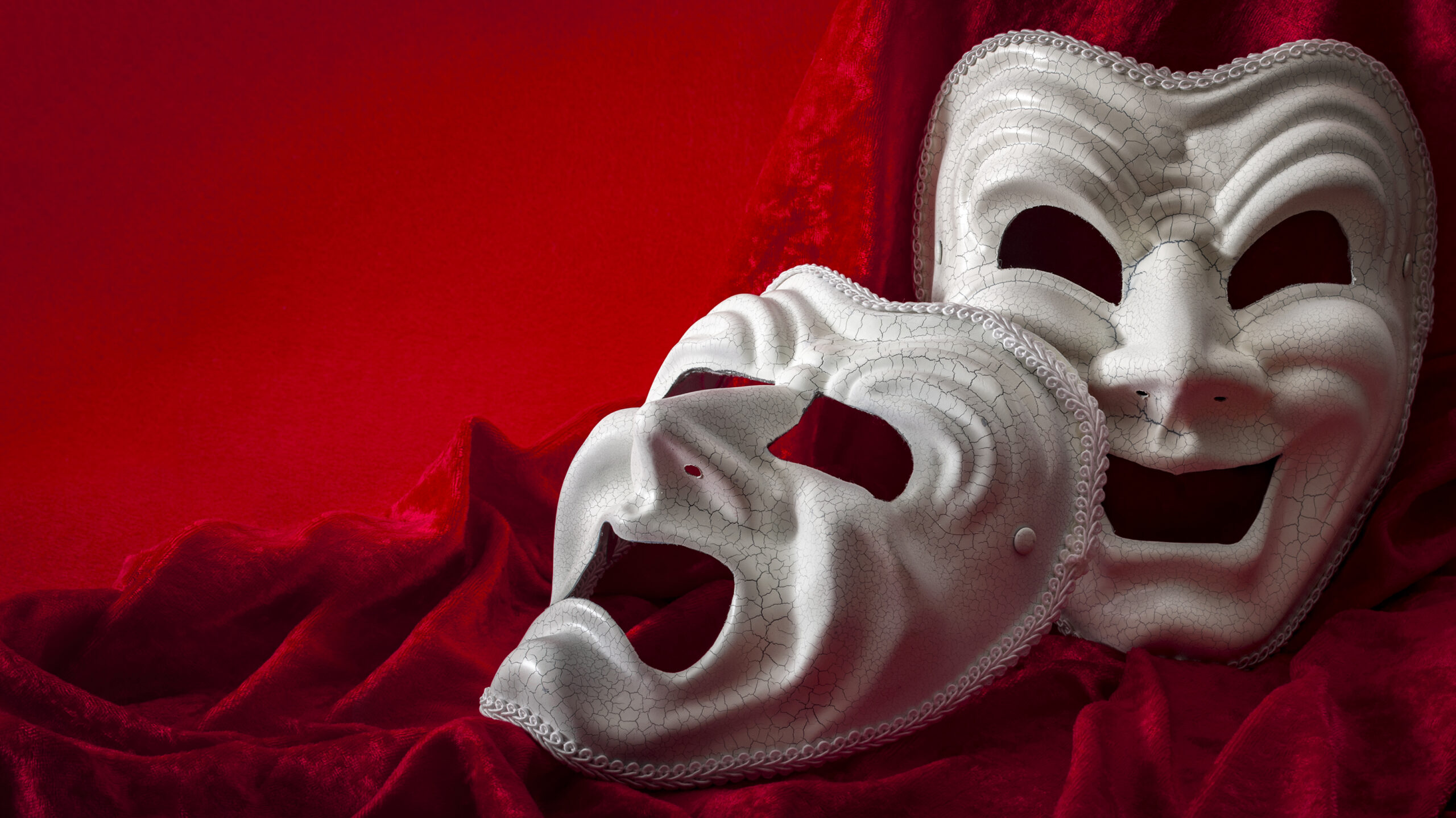 Theatre and opera concept with theatrical masks on red velvet